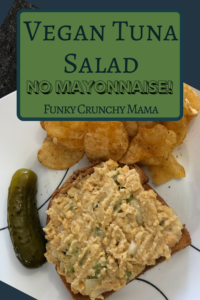 Pinterest image for Funky Crunchy Mama's vegan tuna salad without mayo. Image is an open faced vegan tuna sandwich on a white plate with a pickle and potato chips. 