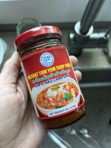 Image of a small jar of  Two Horses brand Tom Yum soup paste. 